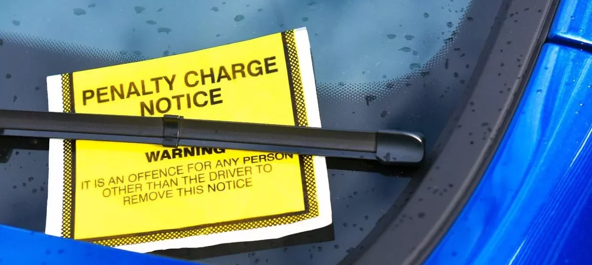 0_Parking ticket on blue car e1764683720193